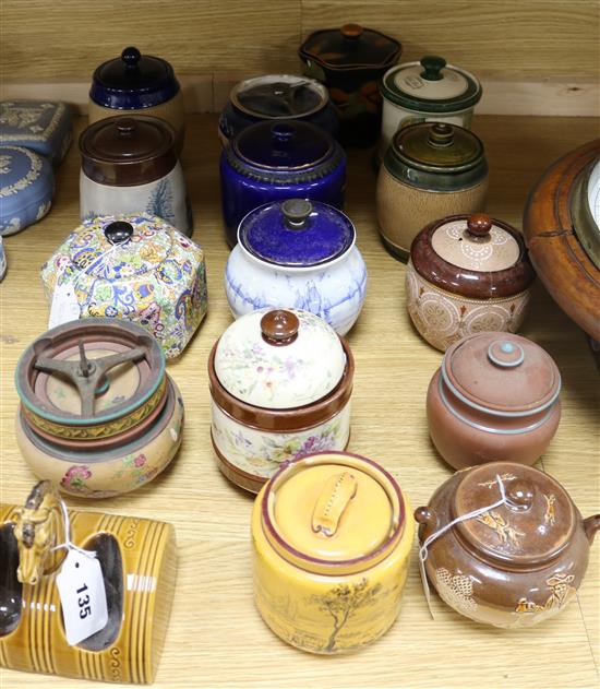 A Royal Doulton tobacco jar, 14 other tobacco jars, various and a pottery horse head pipe rack (16)
